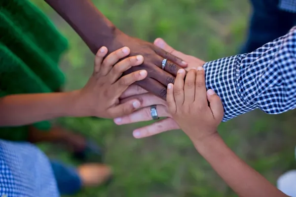 Manos unidas representando el apoyo comunitario en el proceso de adopción